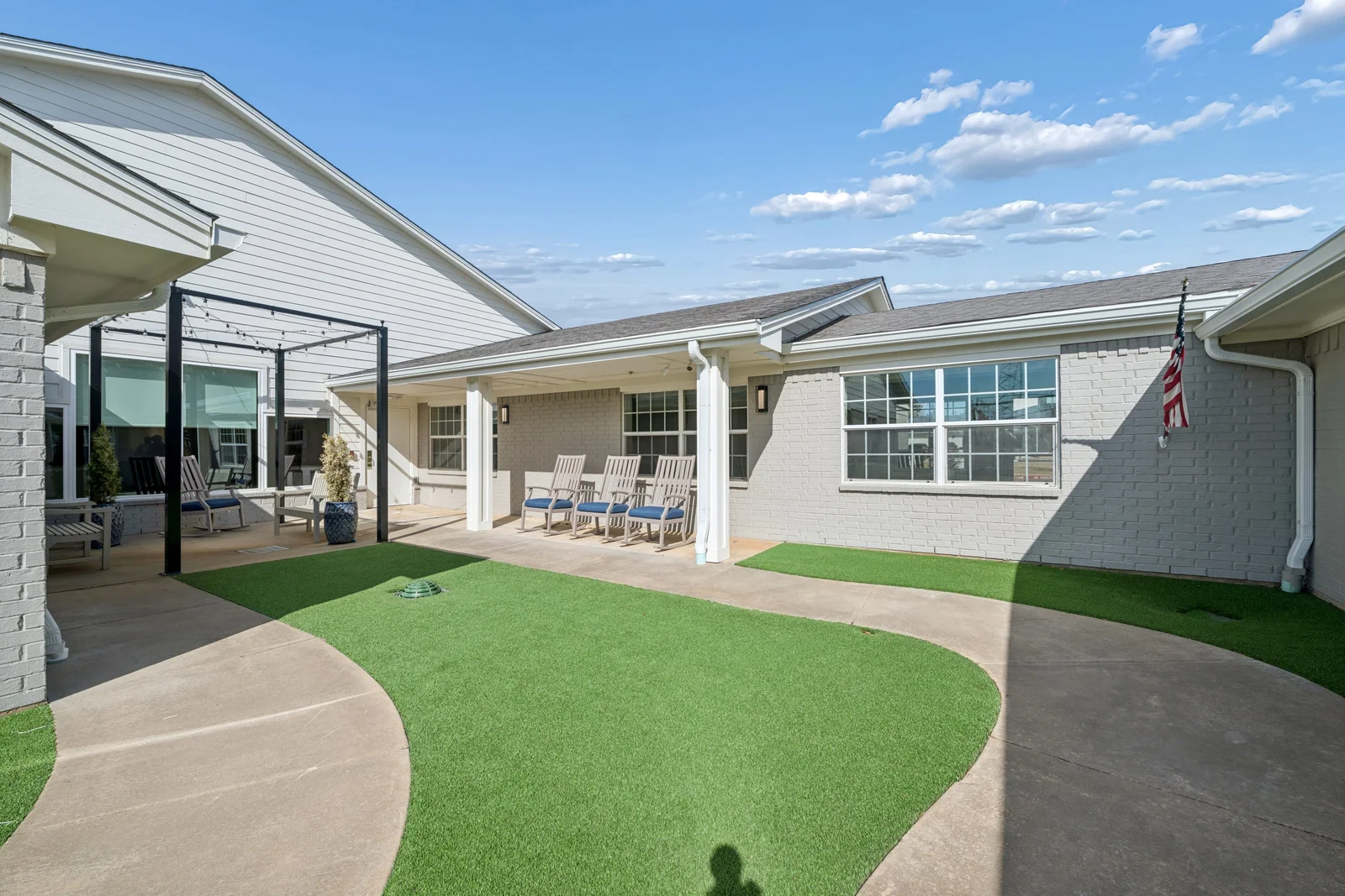 Secured outdoor courtyard with walking paths and seating areas