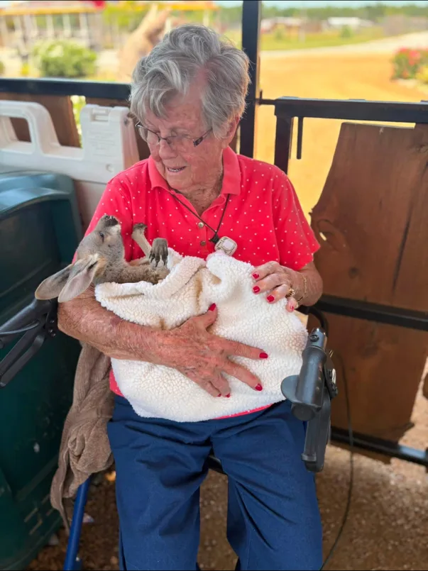 Resident Holding a Baby Kangaroo