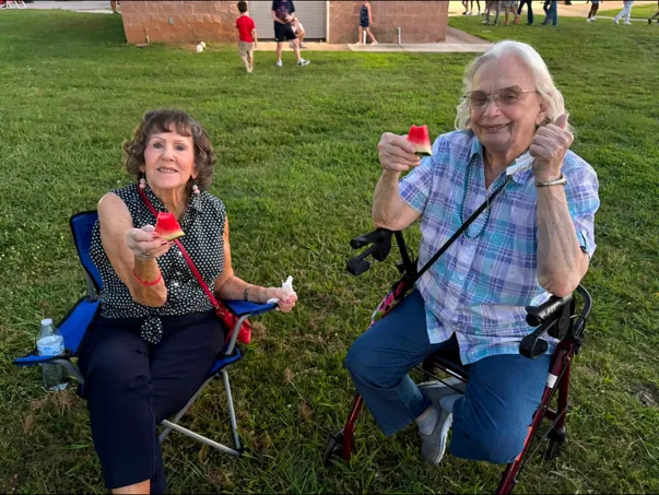 Residents Enjoying Watermelon Outdoors